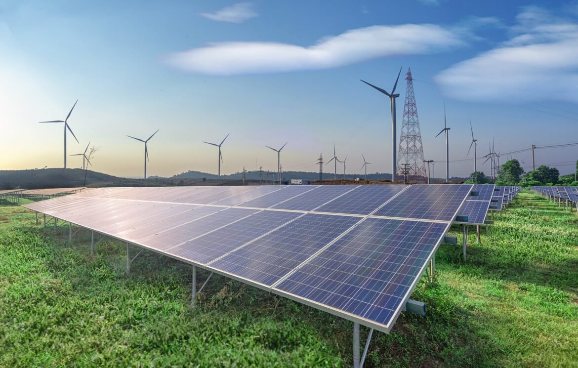 renewable-energy-solar-panels-wind-turbines-green-grass-blue-sky renewable-energy-solar-panels-wind-turbines-green-grass-blue-sky